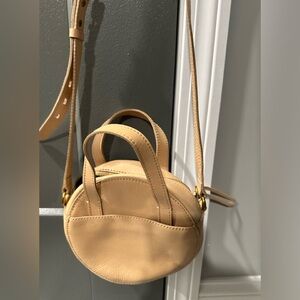 The Juno Circle Crossbody Bag. Color: Linen